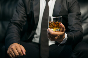 Businessmen in suits drinking whiskey