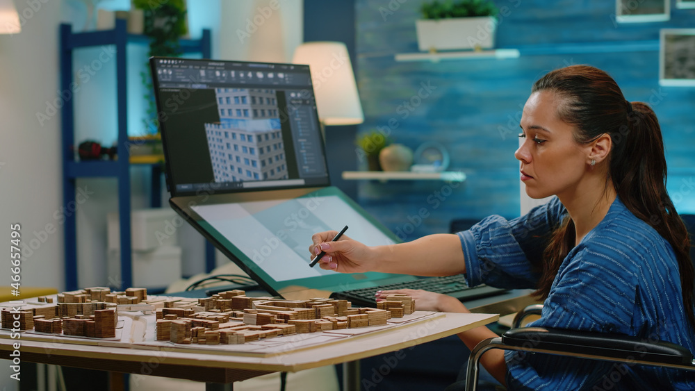 Poster woman with disability using touch screen for construction layout at office. architect in wheelchair 
