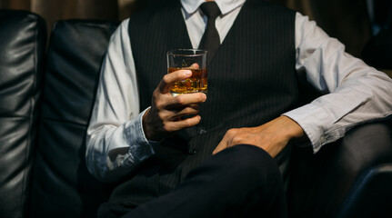 Businessmen in suits drinking whiskey