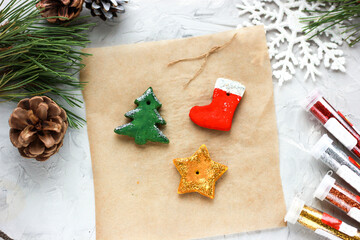 sprinkling with multi-colored glitter stars, Christmas trees, Christmas socks, DIY toys for the New Year, creative decoration for a Christmas tree made of salt dough