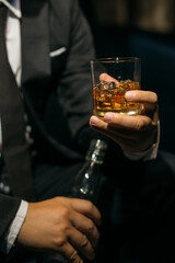 Businessmen in suits drinking whiskey