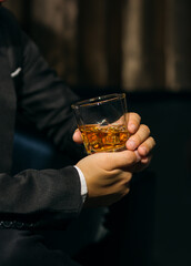 Businessmen in suits drinking whiskey