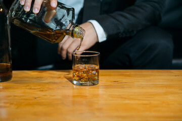 Businessmen in suits drinking whiskey
