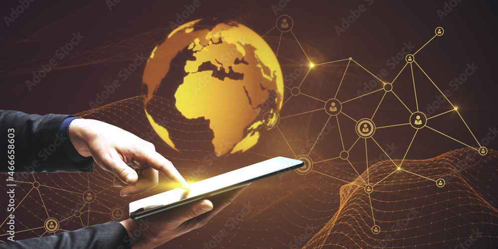 Poster close up of businessman hand pointing at tablet with glowing globe hologram with polygonal mesh on d