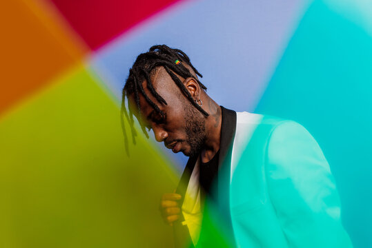 Man Looking At Multi Colored Umbrella