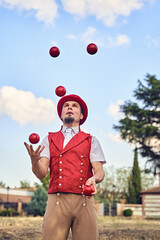 Man juggling balls in park
