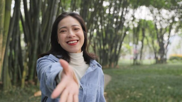 lovely asian girlfriend in the park smile at camera slow motion