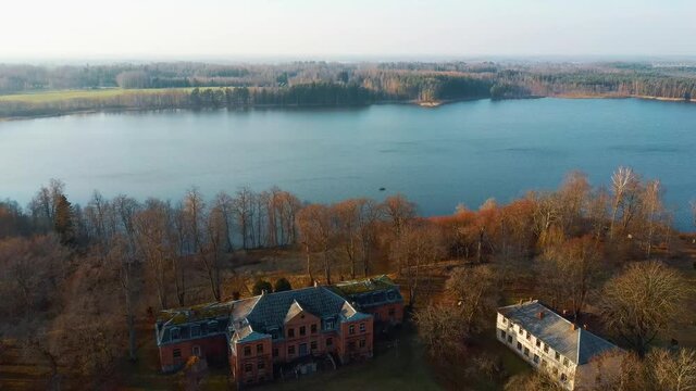 Old Red Brick House, Katvari Manor in Latvia and Katvaru Lake in the Background. View From Above. In the Manor Territory Is a Big Park With Hundred-year Old Linden. Aerial Dron Shot 4K Resolution