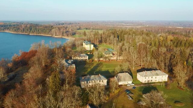 Old Red Brick House, Katvari Manor in Latvia and Katvaru Lake in the Background. View From Above. In the Manor Territory Is a Big Park With Hundred-year Old Linden. Aerial Dron Shot 4K Resolution