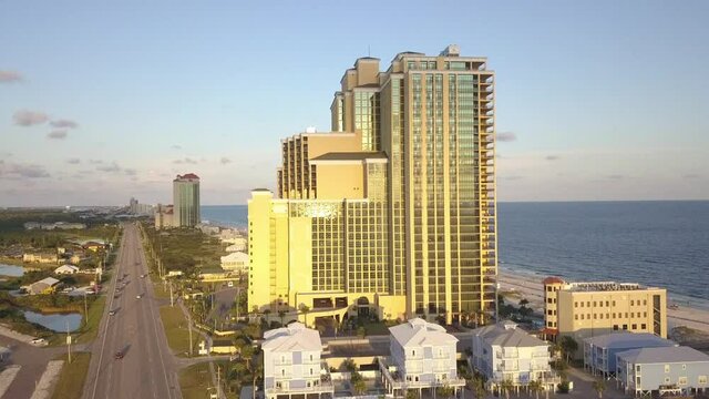 Skyscrapers And National Highway at The Shore Of Orange Beach In Alabama, USA. aerial, forward
