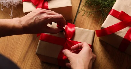 Hands of cropped unrecognisable woman packing Christmas present, Eco friendly packaging kraft paper gifts, Female wrapping a Christmas present, gift box