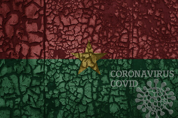 flag of burkina faso on a old metal rusty cracked wall with text coronavirus, covid, and virus picture.