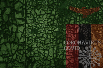 flag of zambia on a old metal rusty cracked wall with text coronavirus, covid, and virus picture.