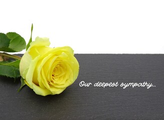 Deepest sympathy card with yellow rose on a slate with text 'Our deepest sympathy'.