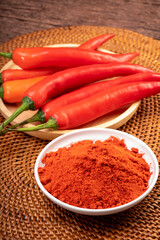 Korean pepper powder and red pepper in wooden plate, Korean  chili powder on wooden table background
