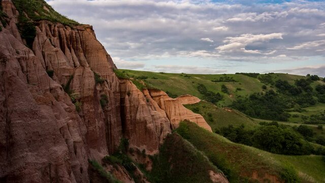 Timelapse of sunset over Rapa Rosie marl cliffs in Romania