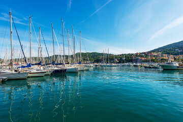 Fototapeta na wymiar Large group of sailing boats moored in the port of the small village of Lerici, tourist resort on the coast of Gulf of La Spezia, Mediterranean sea, Liguria, Italy, Southern Europe.