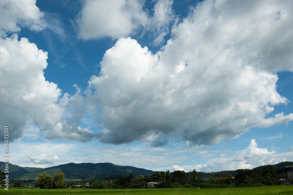 Wall mural the white clouds have a strange shape and moutain.the sky and the open space have mountains below.cl