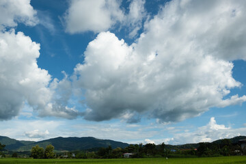 The white clouds have a strange shape and moutain.The sky and the open space have mountains below.Clouds floating above the mountains.