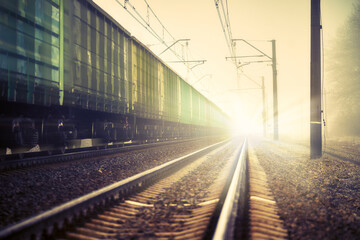 Railroad tracks vanishing into the perspective. Winter, Snow-covered railway. On railway tracks moving train. Cross process image.