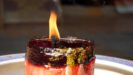 burning candle in a glass