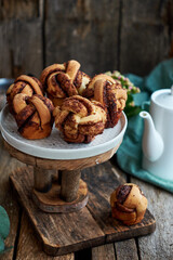 Cinnamon rolls, round yeast buns. Side view, wooden background.
