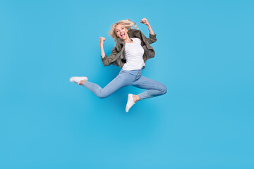 Fototapeta na wymiar Full length body size photo woman jumping up showing strong hands isolated pastel blue color background