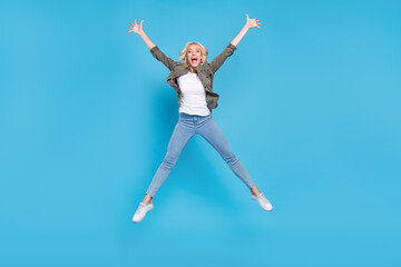 Fototapeta na wymiar Full length body size photo amazed woman jumping up careless happy isolated pastel blue color background