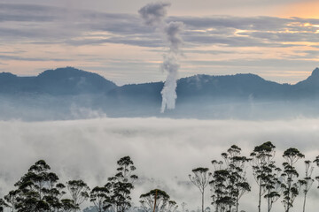 The view of the hills and tea gardens is shrouded in mist. You can find this view at the location of sky garden Pangalengan - Bandung.