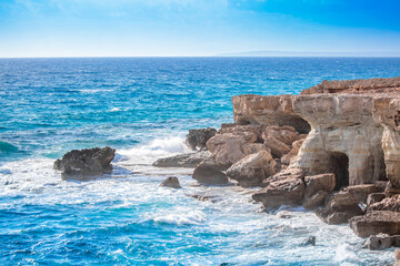 Beautiful scenic rocks in Cyprus caves and grottoes on the shores of the Mediterranean, a background with beautiful rock texture as a concept of travel and tourism travel