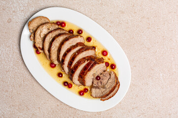 Rolled roasted veal sliced, decorated with cranberries. Italian traditional dish Arrosto di vitello.