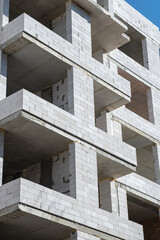 Construction of an apartment building. Monolithic concrete structure and foam block.