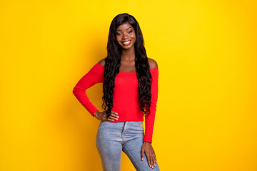 Photo of pretty sweet dark skin girl dressed red top arm waist standing isolated yellow color background