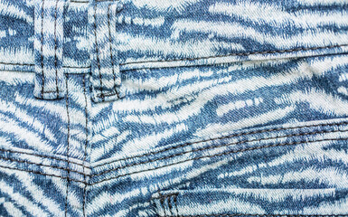 Jeans background. Denim fabric closeup. Textures of clothing fabric with fashion embroidery blue colors. Copy space for text. Fashion and Style.