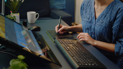 Close up of photo editing equipment at photography studio on desk. Woman working as editor using...