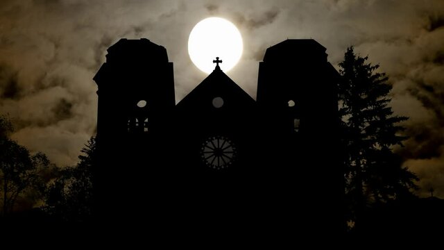 Santa Fe by Night with Dark Atmosphere, Fog, Smoke, Full Moon and Silhouette of Saint Francis Cathedral, New Mexico
