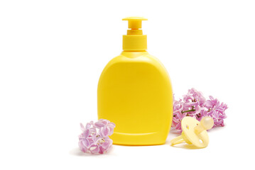 baby liquid soap, pacifier and lilac flowers isolated on white background