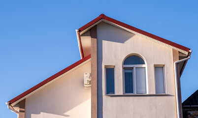 Facade of a small compact two-story house.