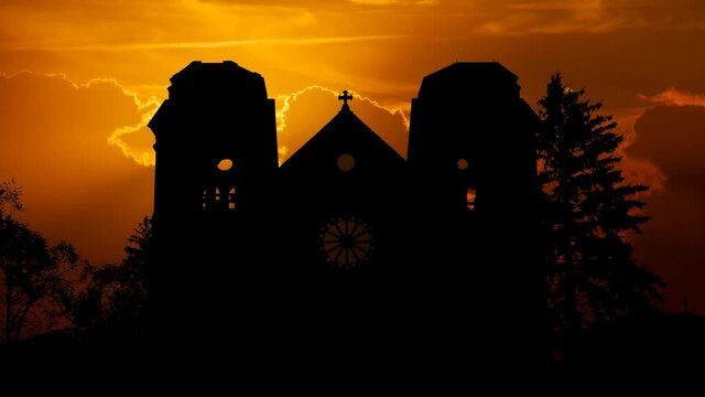 New Mexico: Cathedral in downtown of Santa Fe, Time Lapse at Sunset with Red Sun and Fiery Sky, USA