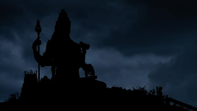 Hinduism Temple with Lightning and thunderstorm flash over Lord Shiva God in Silhouette