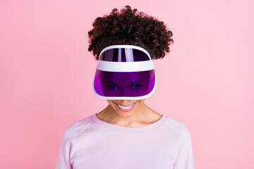 Portrait of young funky smiling childish african female wear visor fooling around isolated on pink...