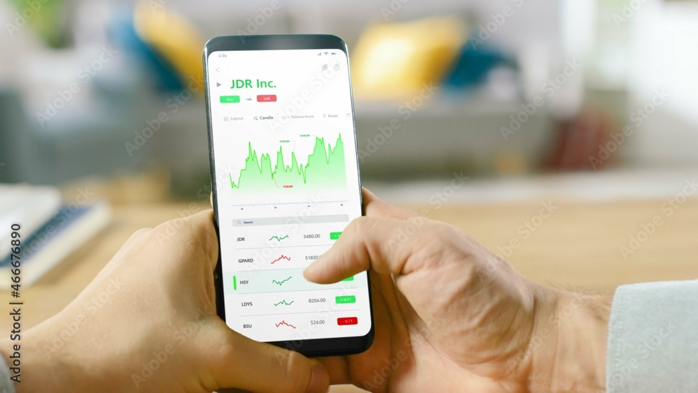 Poster close-up shot of smartphone. man is using stock market app to check share prices. graph is going up 