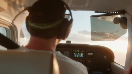 Man flying a small Cessna plane during the sunrise. - Powered by Adobe