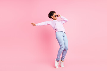 Full size photo of young smiling energetic african woman dancing enjoying weekend free time...