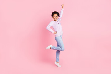 Fototapeta na wymiar Full size photo of young good mood cheerful excited afro girl raise fist in victory triumph isolated on pink color background