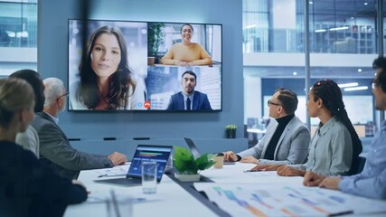 Video Conference Call in Office Boardroom Meeting Room: Executive Directors Talk with Group of Multi-Ethnic Entrepreneurs, Managers, Investors. Businesspeople Discuss e-Commerce Investment Strategy - Powered by Adobe