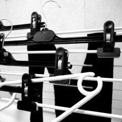 Black and white hangers on drying rack