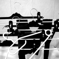 Black and white hangers on drying rack 