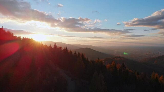 Epic cinematic beatiful and smooth fly above autumn forest mountains and Bielsko-Biała city. Tilt up. 