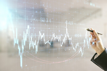 Double exposure of man hand with pen working with abstract creative financial chart hologram on blurred office background, research and strategy concept